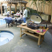 Primo Oval XL 400 Ceramic Kamado Grill On Curved Cypress Table With Stainless Steel Grates | GW STORE